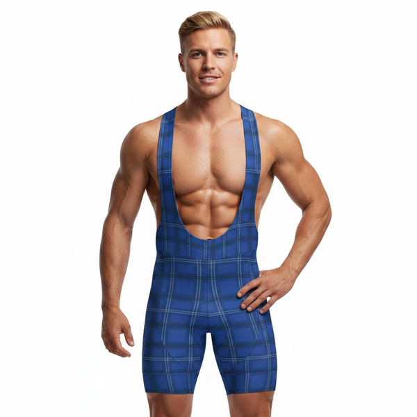 A muscular male model wearing a blue and navy plaid bib-style one-piece shorts, standing against a solid white background.